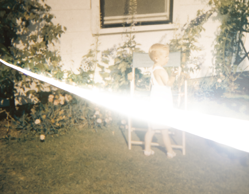 A process image by Amy Friend of young boy outside by lawn chair