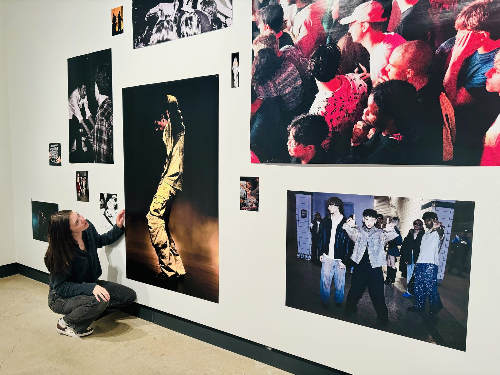 Photo of VISA student Cleah Fast installing her photos in the VISA Gallery