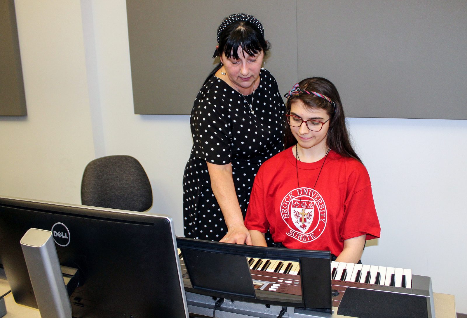 Brock student a keyboard at the french music festival with teacher