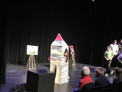 actors on stage during a play