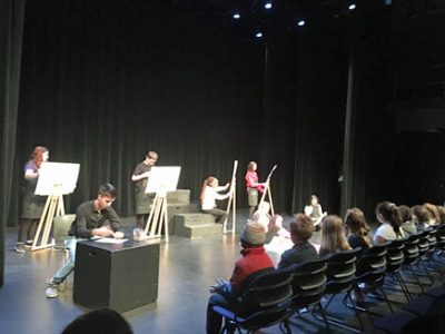 actors on stage during a play