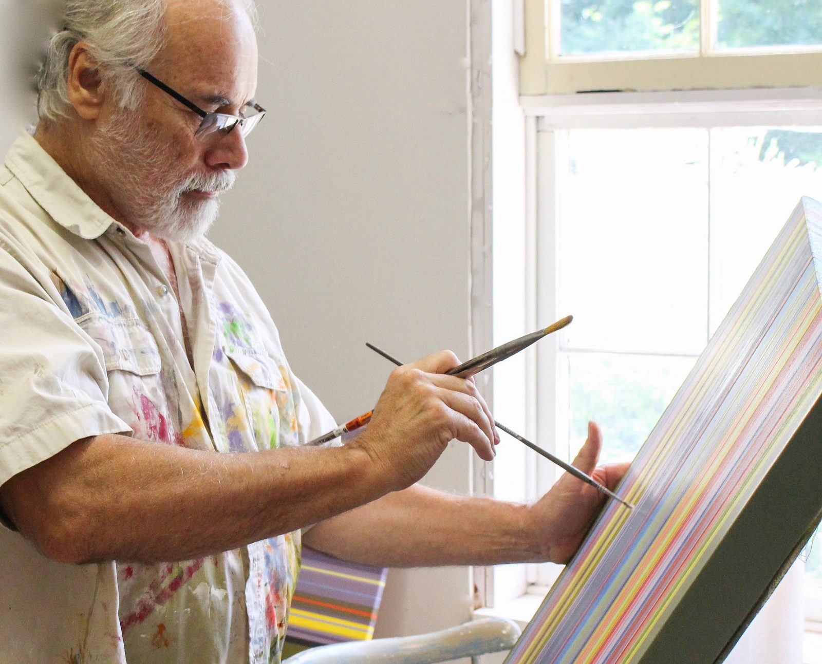 Murray Kropf painting at easel
