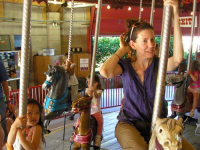 Marlene Moser and 3 children riding the Lakeside Park Carousel