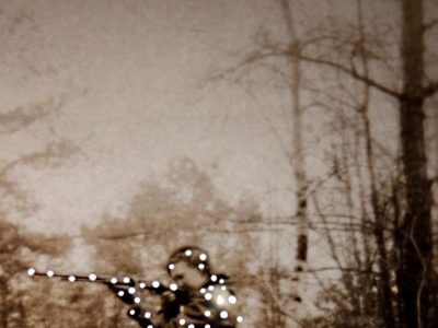 Professor Amy Friend’s photograph Ruth, woman holding gun with light orbs over her figure