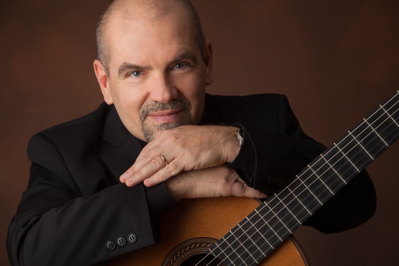 Tim Phelan poses with his guitar.
