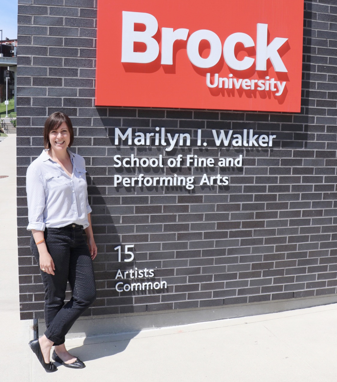 History Elizabeth Vlossak in front of Marilyn I Walker Artist commons sign