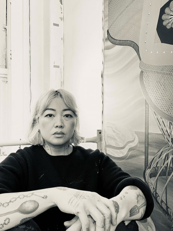 Marigold Santos sits in an industrial space.