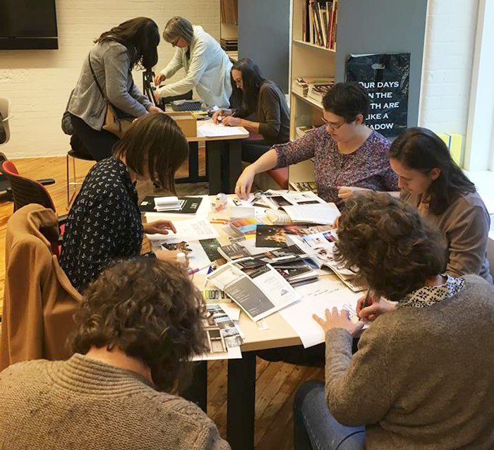 People are seen cutting magazines, drawing and colouring to create their own zines.