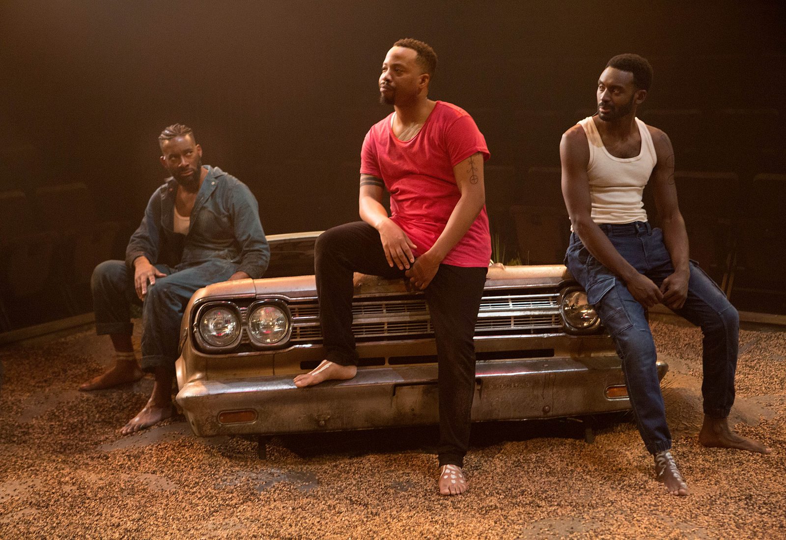 Daren A. Herbert, Mazin Elsadig and Marcel Stewart on hood of a 50's car