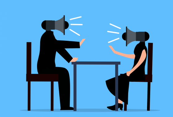 Image shows two people arguing with each other. Instead of heads, these characters have speakers on their heads to emphasize the disagreement