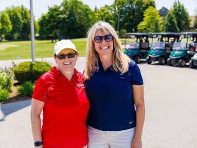 Lesley Rigg and Melissa Krist posing in golf atire