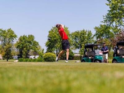 Low angle shot of a golfer tee off