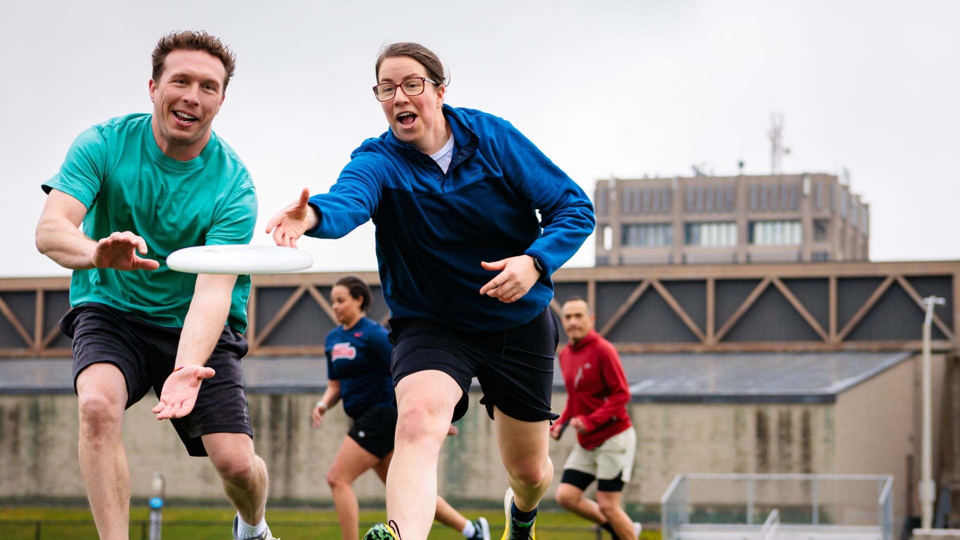 adults playing ultimate frisbee 