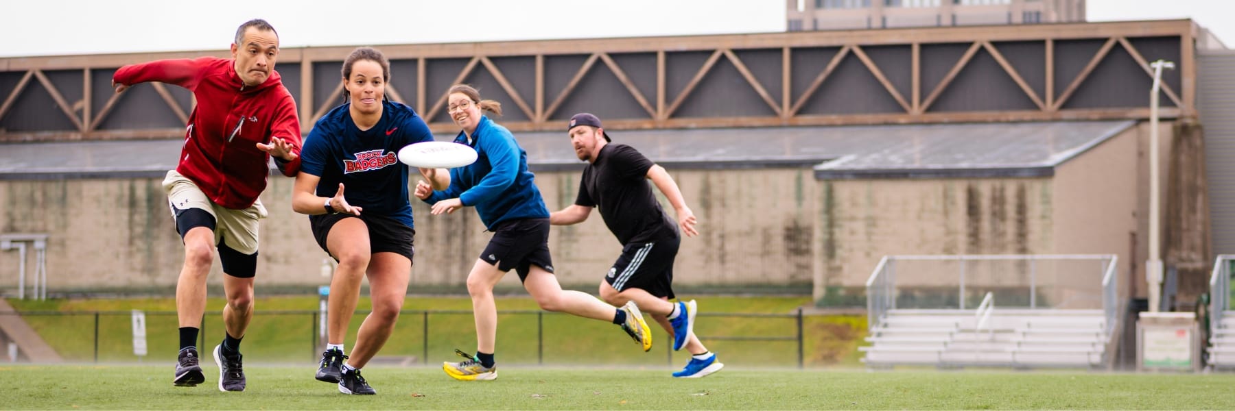 Adults gowing for catch in ultimate frisbee at Brock University