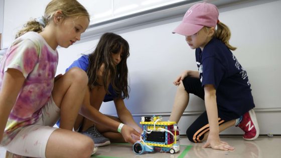 3 children working on LEGO robot