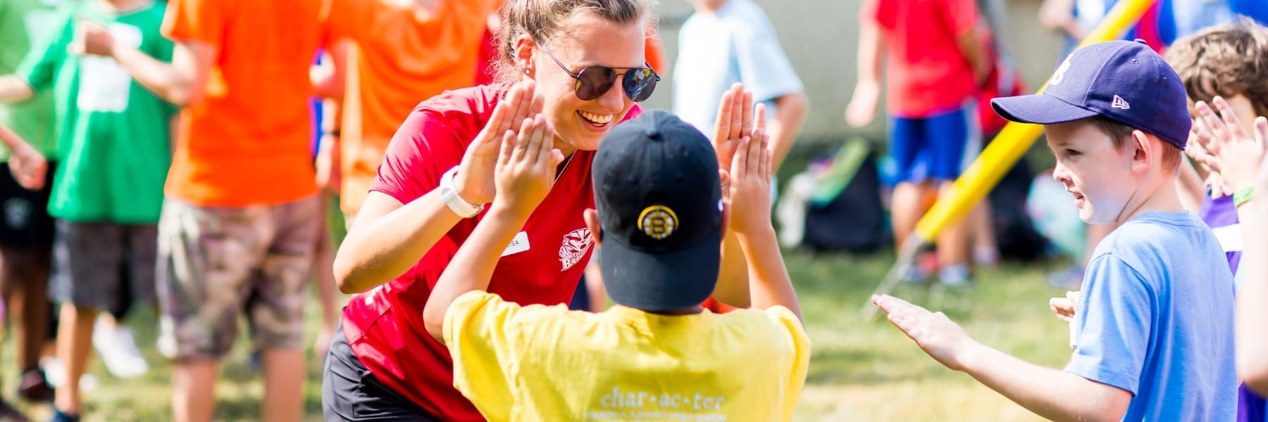 Camp counsellor giving child a high 5