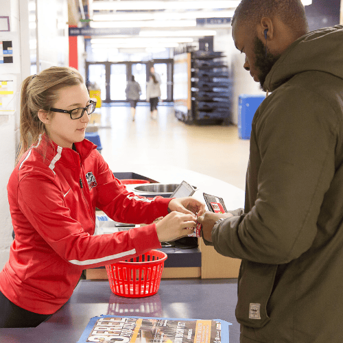Student getting a wristband at the cage