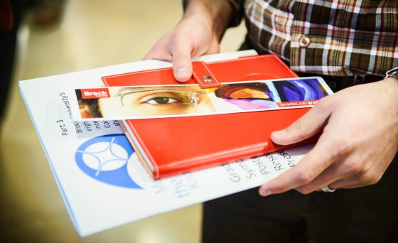 A student holding Brock University promotional materials