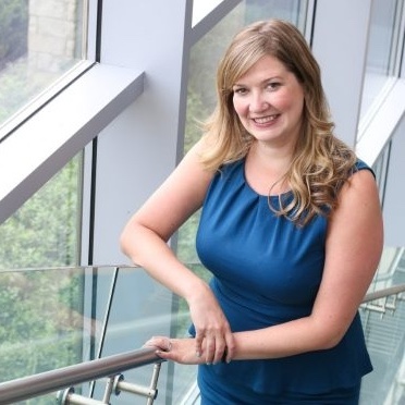 Laura Mullins leaning against a railing