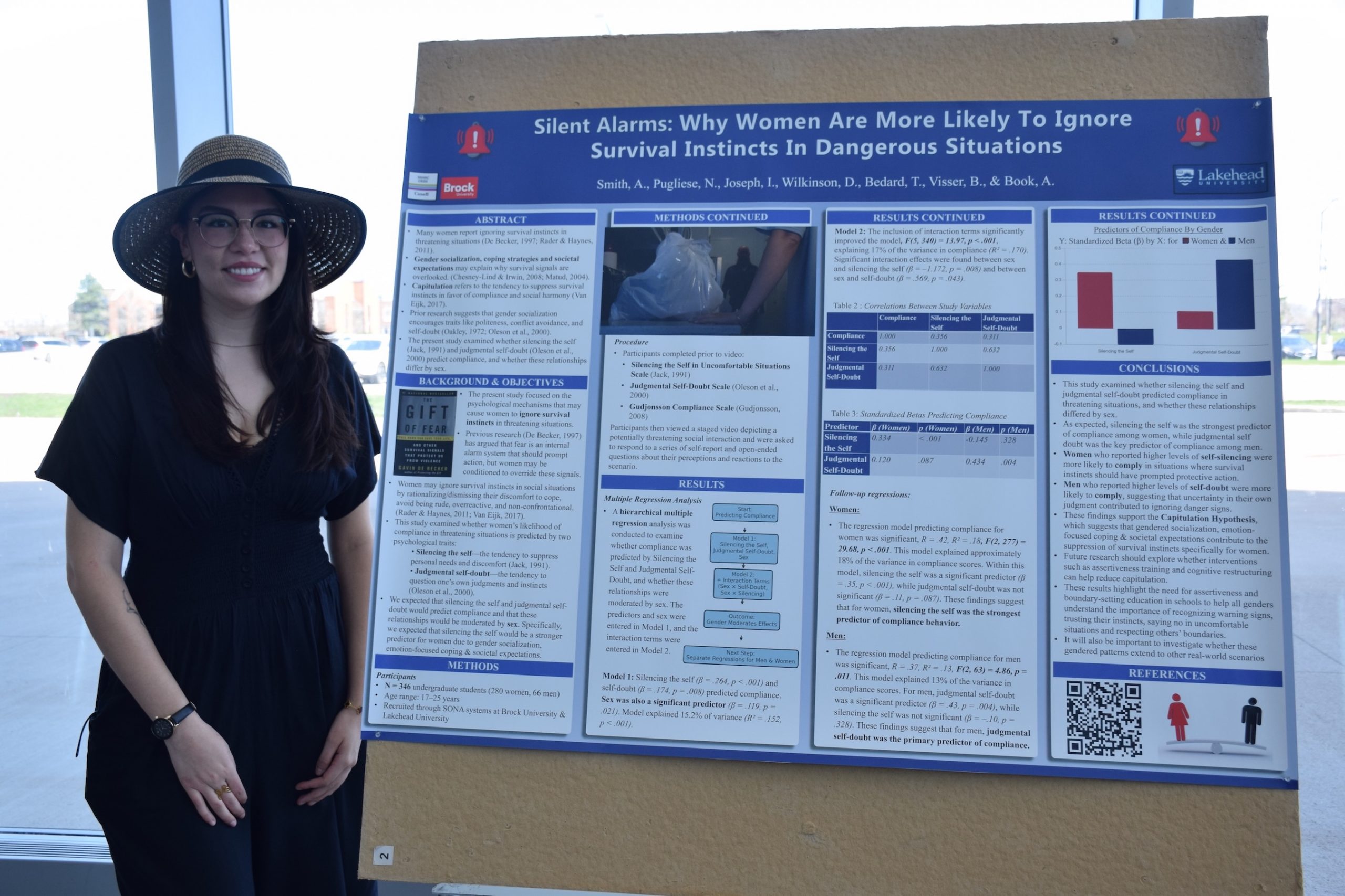 Student standing beside a research poster.