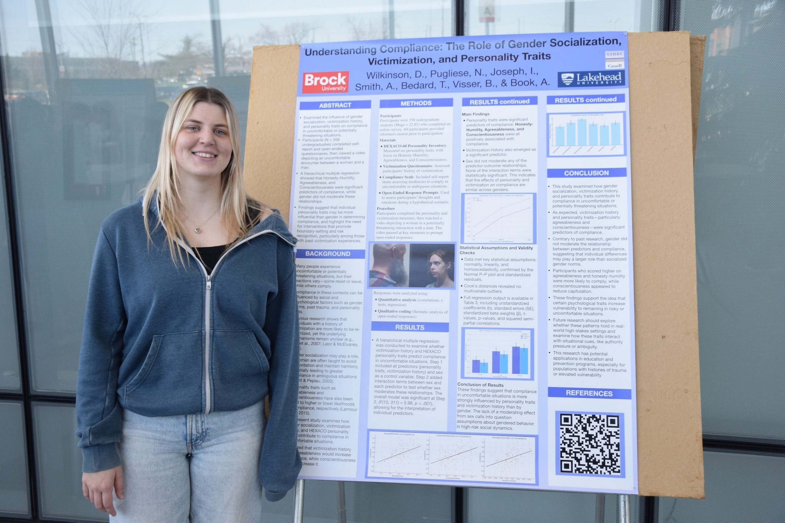 Student standing beside a research poster.