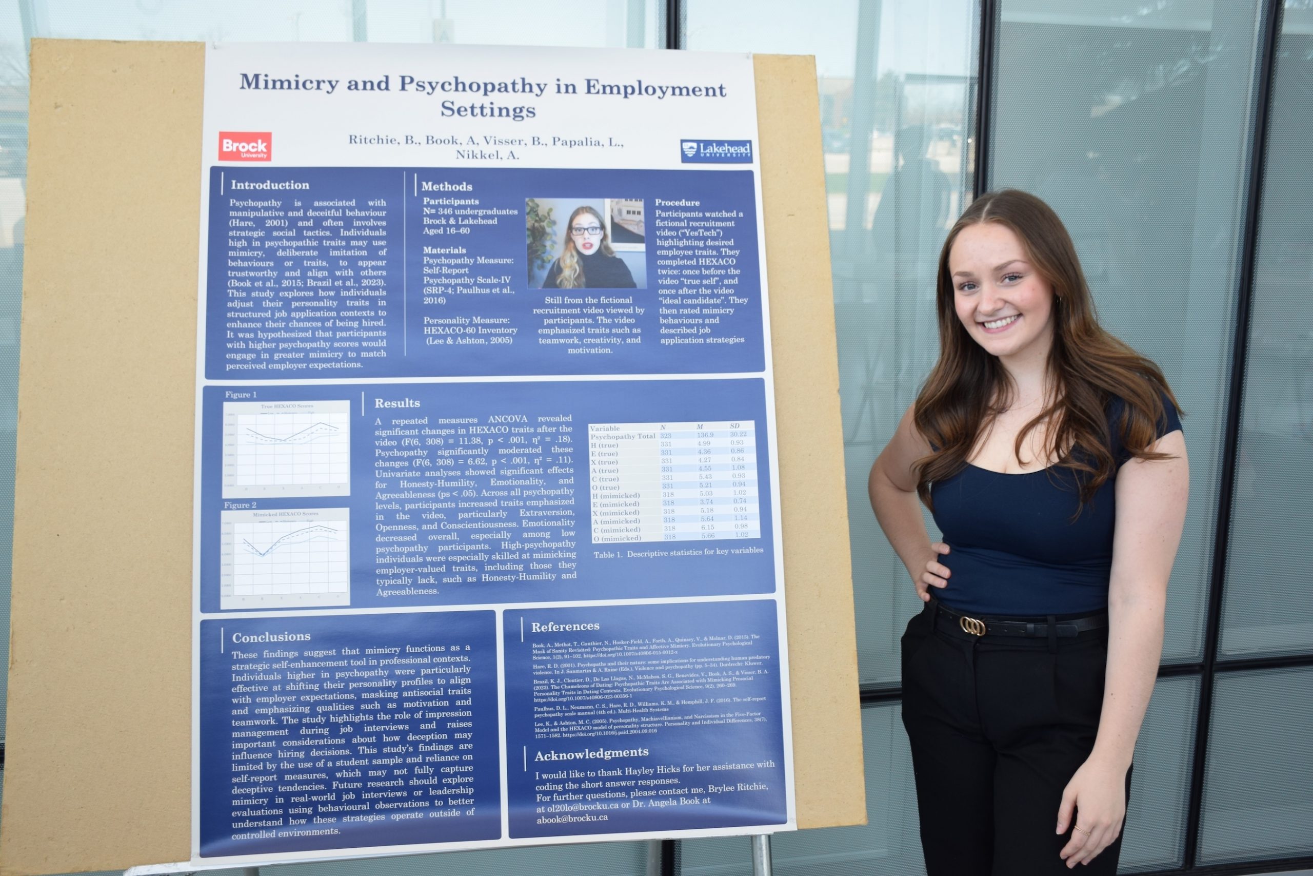 Student standing beside a research poster.