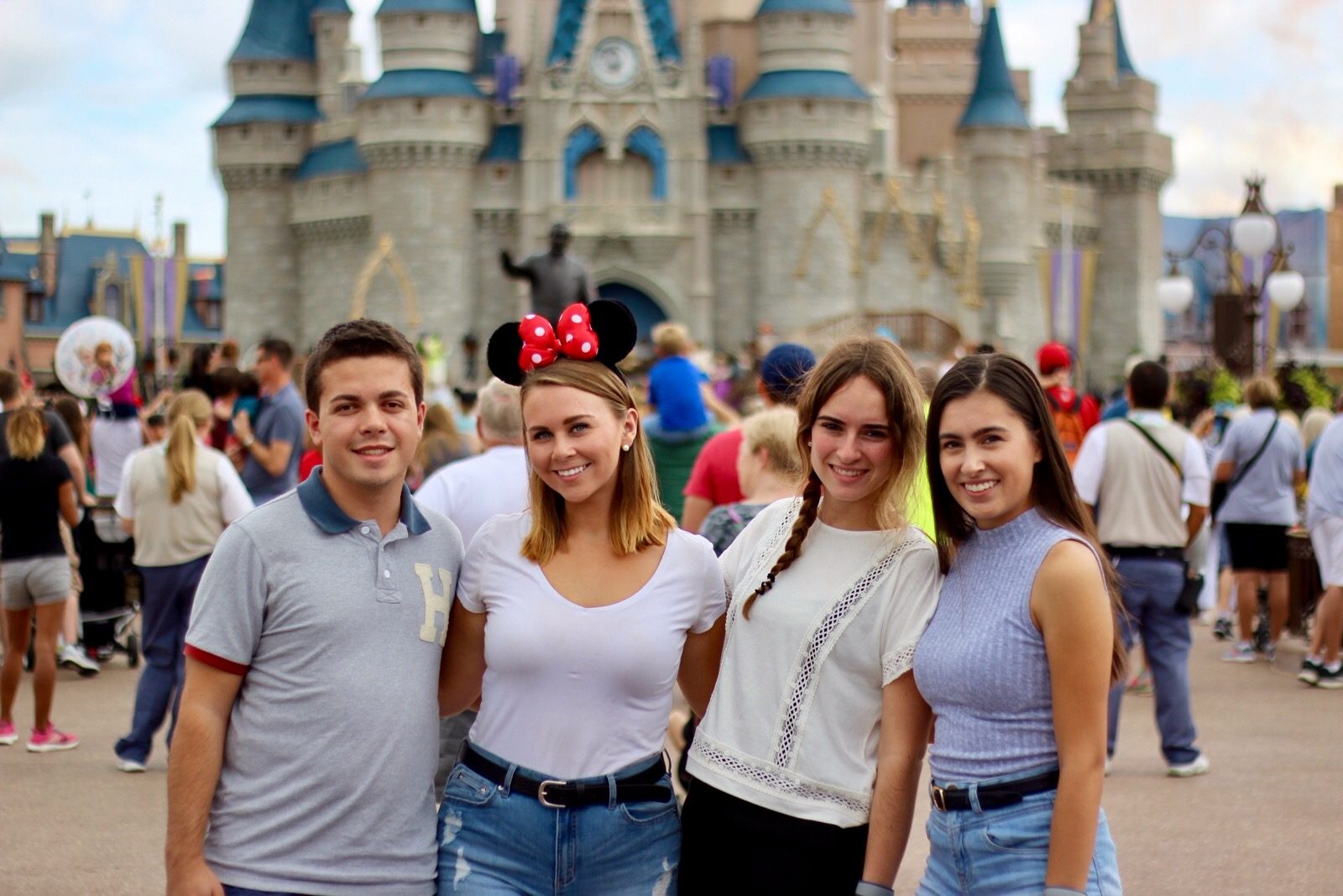 Group of students standing in front of a castle at Disney 
