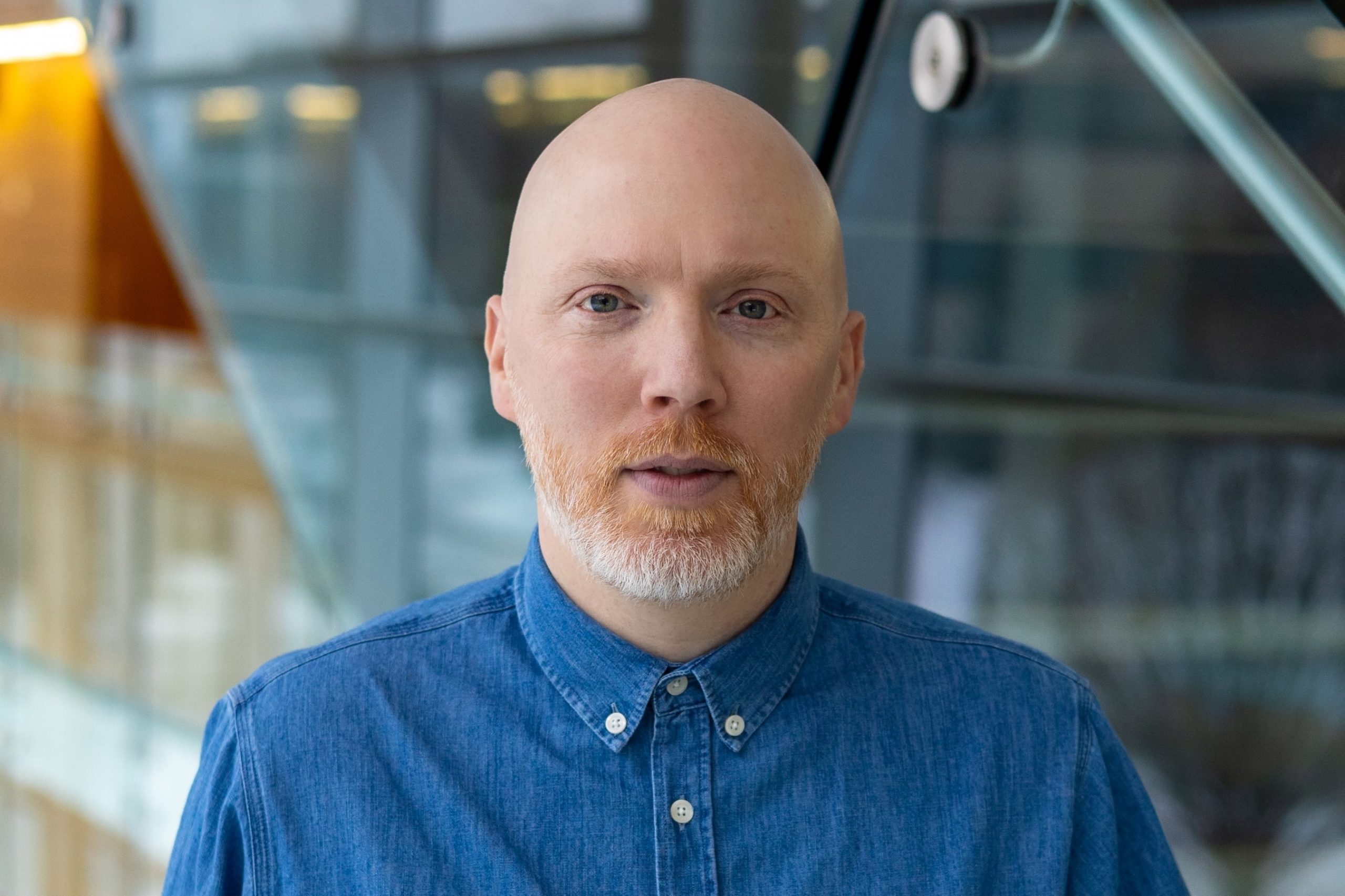 Brock University Associate Professor Simon Black standing on a staircase.