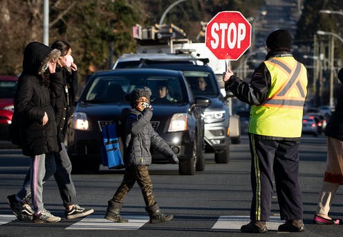 crosswalk with crossing guard holding stop sign