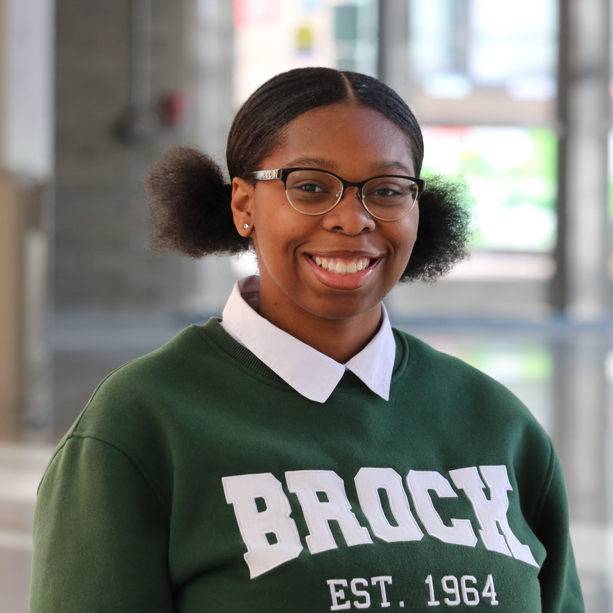 Shadaé Brown standing inside the entrance of Brock University's Rankin Family Pavilion Atrium.