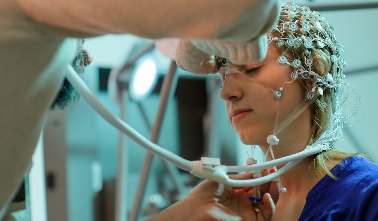 Student with headpiece on for psychology research.
