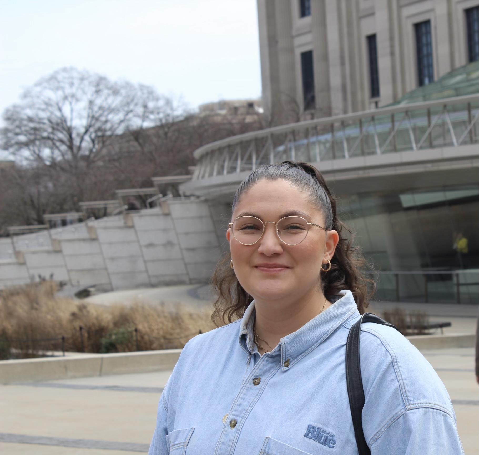 Mitra Mokhtari standing outside in front of a building.