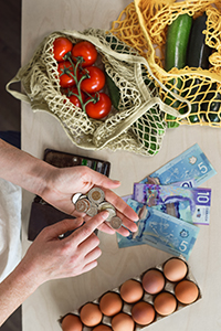 assorted grocery story items and cash on a countertop