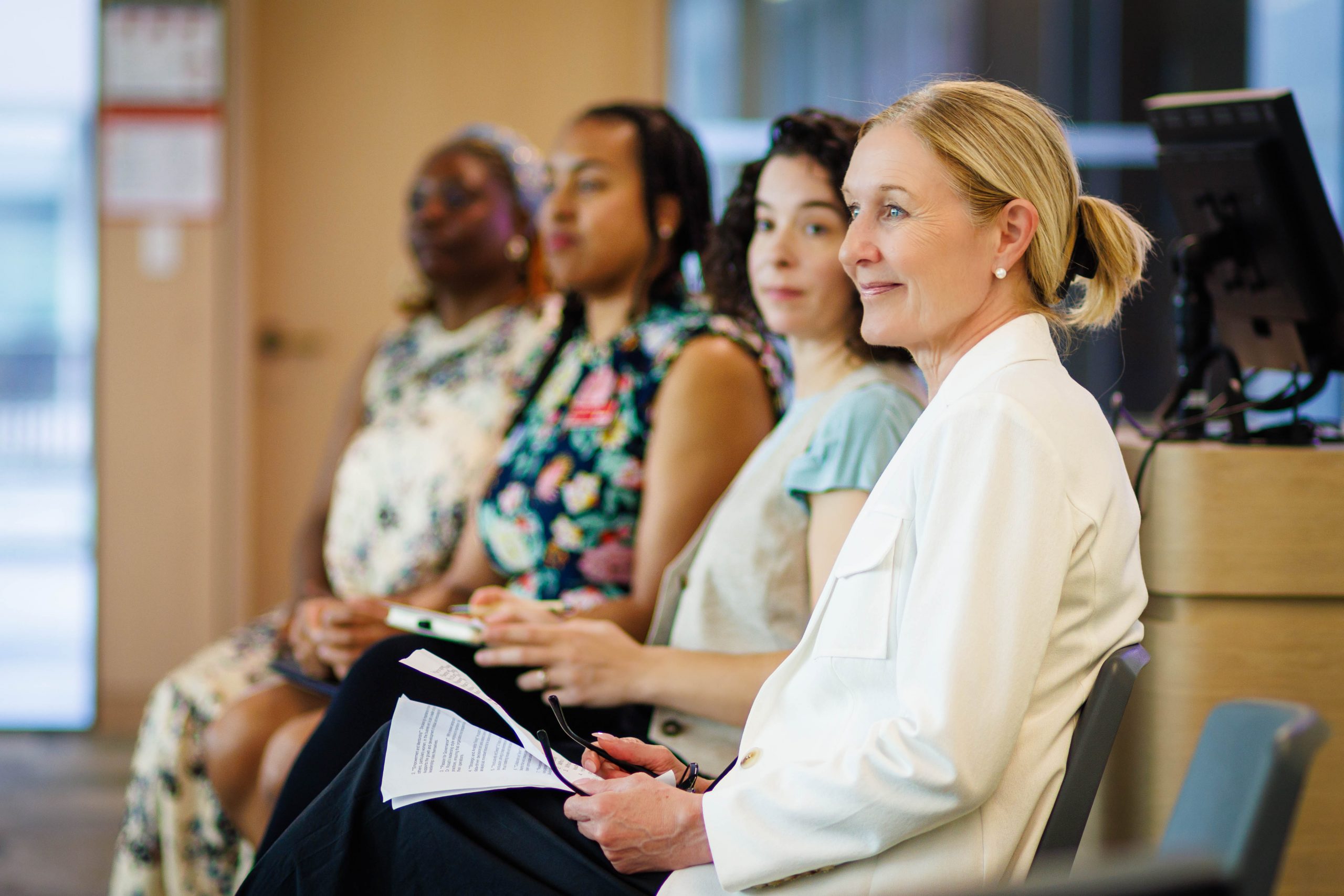 WomenInLeadership-DR Four women sitting on a panel.