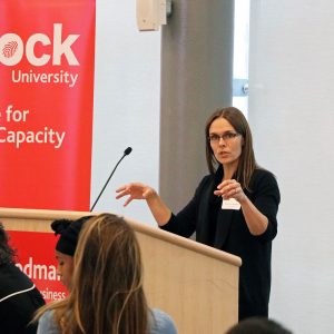 woman at a podium speaking to a crowd
