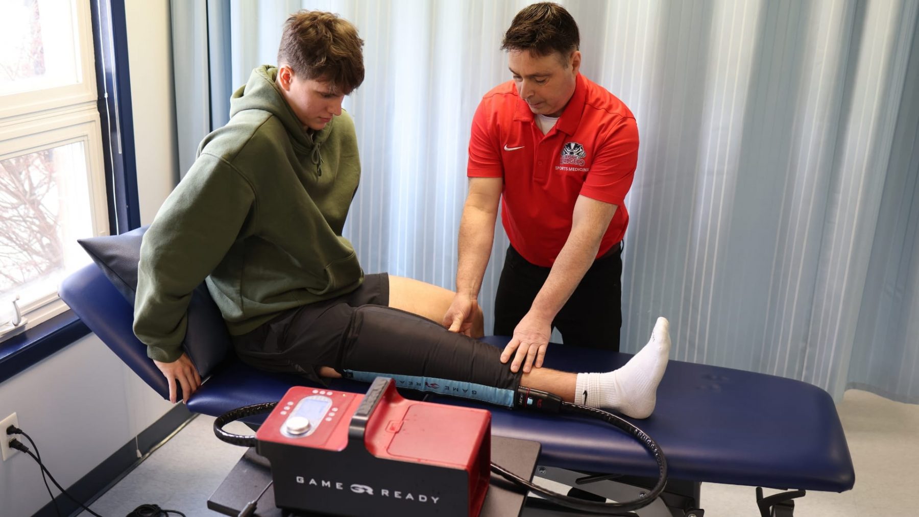 Varsity athlete receiving treatment with game ready equipment