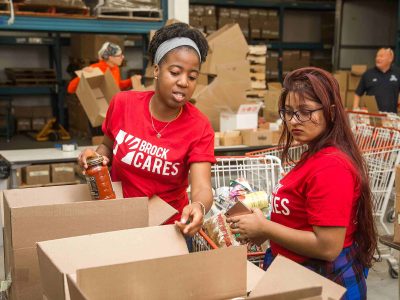 Two students sorting food donations