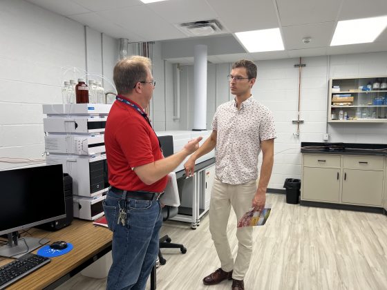 Paul Zelisko presents VPMI research and industry partnership opportunities to MPP Sam Oosterhoff during a facility tour.