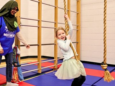 Child on rope swing in Brock's Children's Movement Program