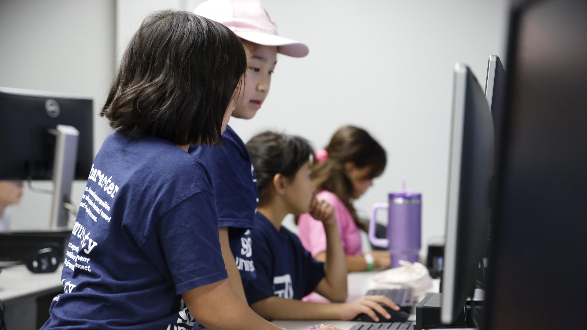 Two campers looking at a computer screen at a Youth University camp 