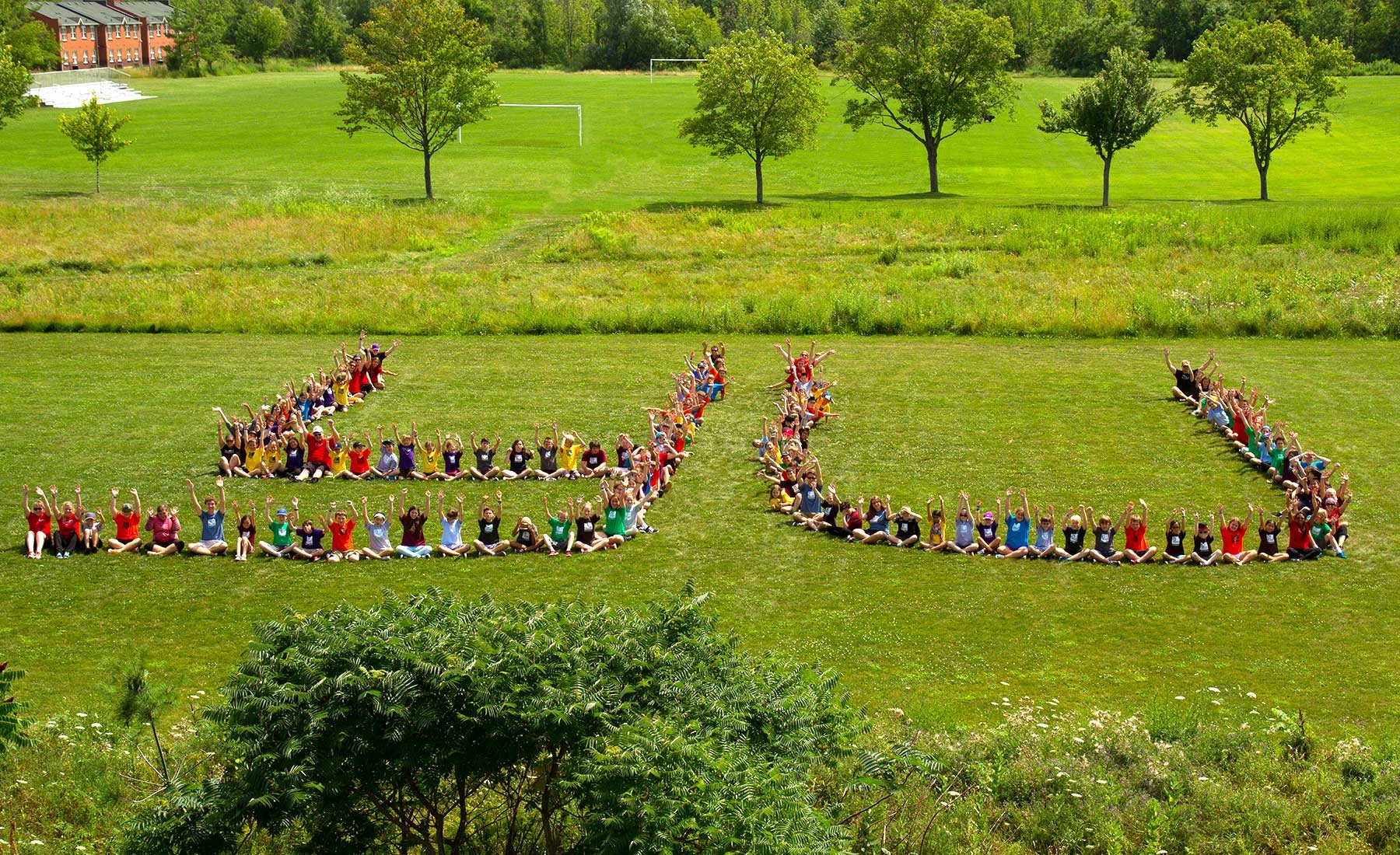 Aerial image of students spelling out Y U